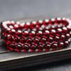 Natural Wine Red Garnet Three Ring Bracelet, with beads approximately 5.6 to 5.7mm in diameter2610169354