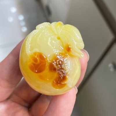 The natural raw mineral white flower cleverly carved and colorful honey wax money bag pendant is approximately 36.6x31.9x29.4mm in size0811790133