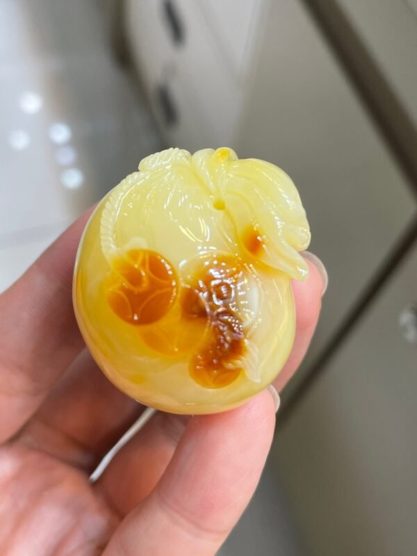 The natural raw mineral white flower cleverly carved and colorful honey wax money bag pendant is approximately 36.6x31.9x29.4mm in size0811790133